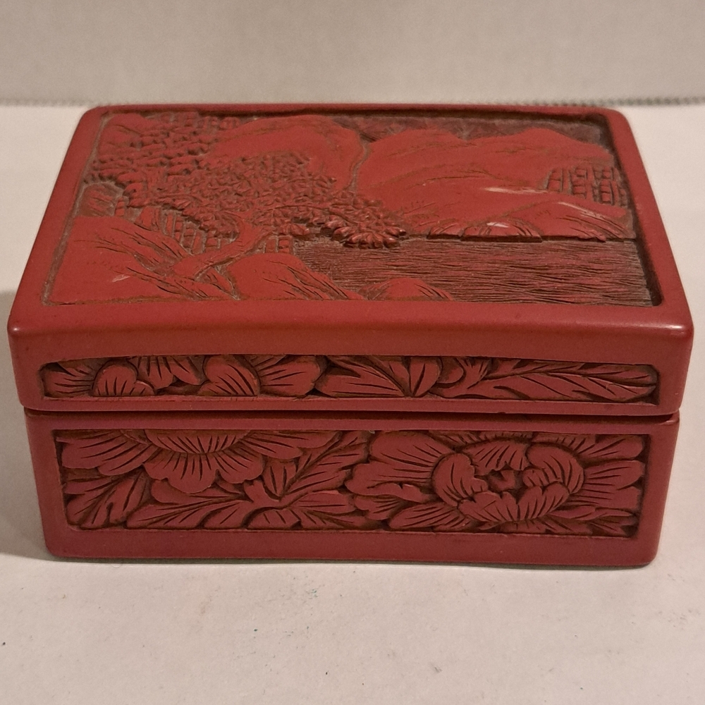 Antique Japanese red cinnabar and black lacquer lidded box with nature design.